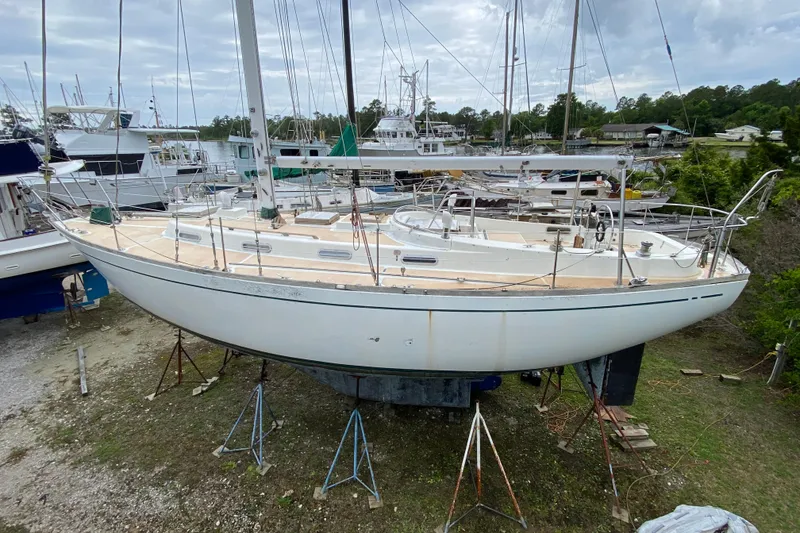 Slide: The Image of Vintage 1979 Fuji 40 sailboat on stands in a marina setting. - 13