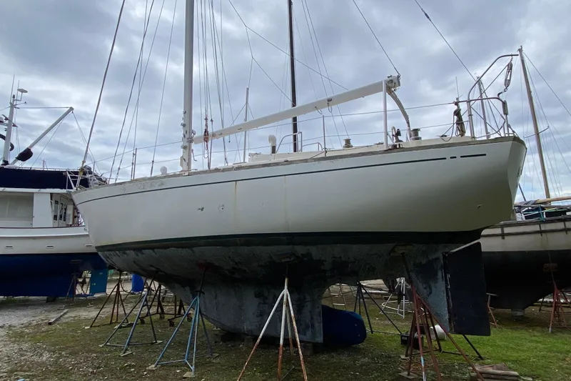 Slide: The Image of Sailboat on stands, Fuji 40 model from 1979, under cloudy sky. - 19