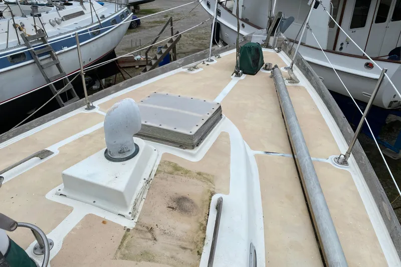 Slide: The Image of Deck of a 1979 Fuji 40 sailboat with visible fittings and railing. - 20