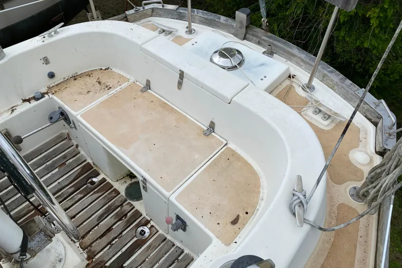 Slide: The Image of Cockpit of a 1979 Fuji 40 sailboat with wooden flooring and storage compartments. - 33