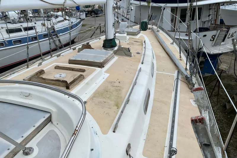 Slide: The Image of Sailboat deck of a 1979 Fuji 40, docked among other boats. - 37