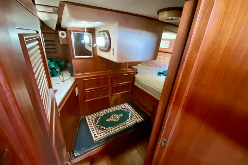 Slide: The Image of Interior of a 1979 Fuji 40 sailboat with wooden cabinetry and a cozy cabin. - 45
