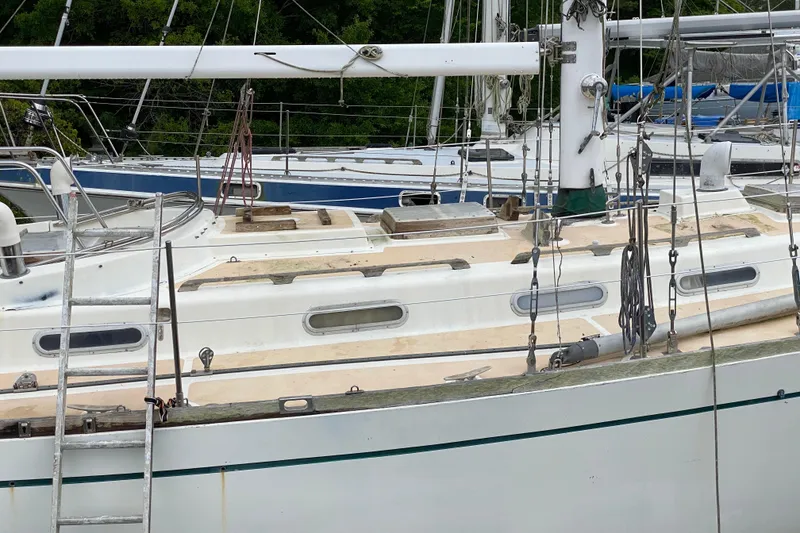Slide: The Image of Sailboat docked, Fuji 40 model from 1979, with visible rigging and deck details. - 5