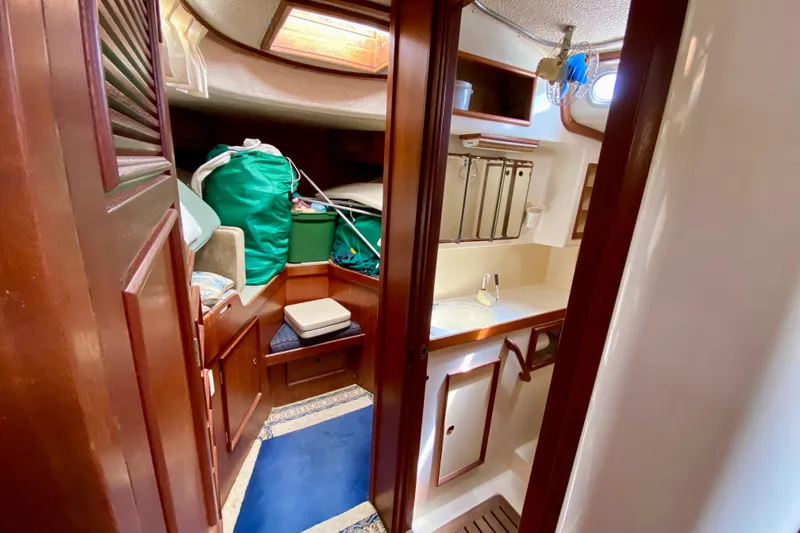 Slide: The Image of Interior of a 1979 Fuji 40 sailboat, featuring a compact cabin and bathroom area. - 50