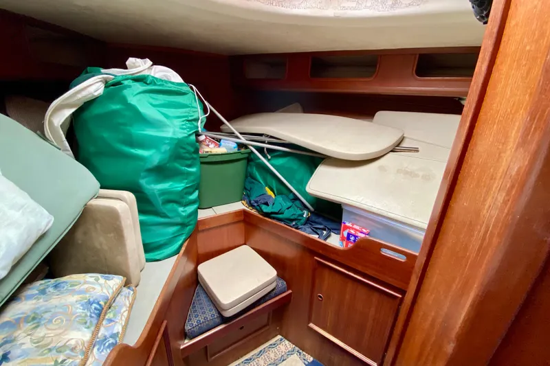 Slide: The Image of Cozy cabin interior of a 1979 Fuji 40 sailboat with storage items. - 52