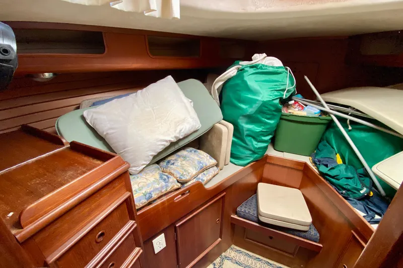 Slide: The Image of Interior of a 1979 Fuji 40 sailboat with cushions and storage items. - 53