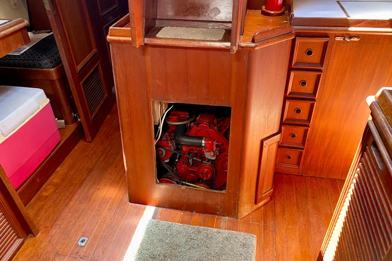 Slide: The Image of Wooden interior of a 1979 Fuji 40 sailboat with visible red engine compartment. - 56