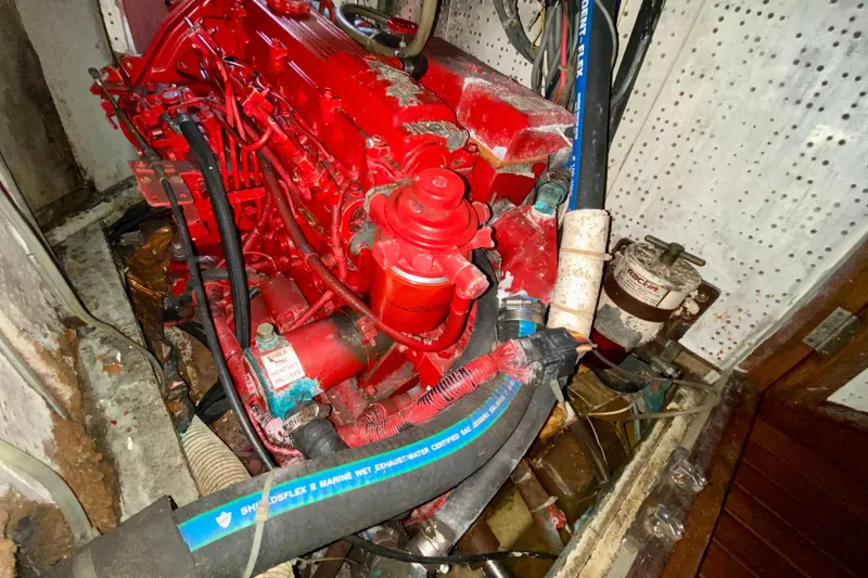 Slide: The Image of Red engine in a 1979 Fuji 40 boat, surrounded by hoses and mechanical components. - 59