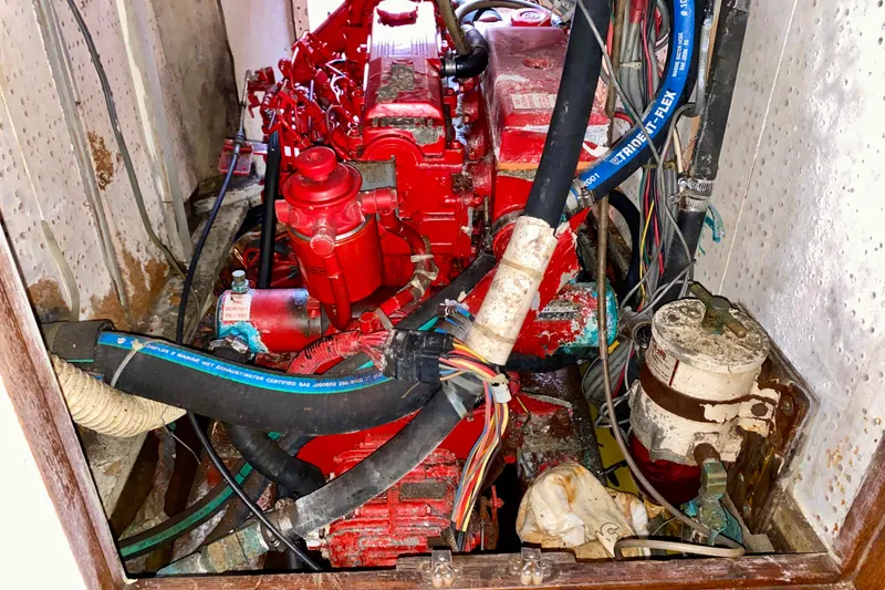 Slide: The Image of Red engine in a 1979 Fuji 40 boat, surrounded by hoses and wires. - 60