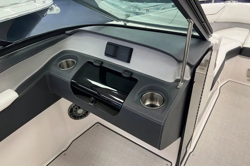 Slide: The Image of 2025 Regal LS4 boat interior with cup holders and sleek dashboard design. - 10