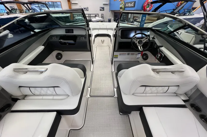 Slide: The Image of Interior of 2025 Regal LS4 boat with white seating and modern dashboard. - 5