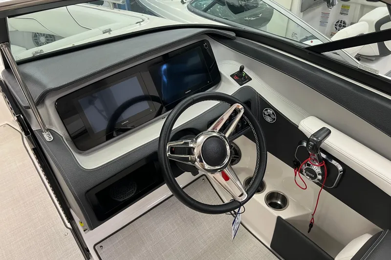 Slide: The Image of 2025 Regal LS4 boat dashboard with modern steering wheel and dual display screens. - 7