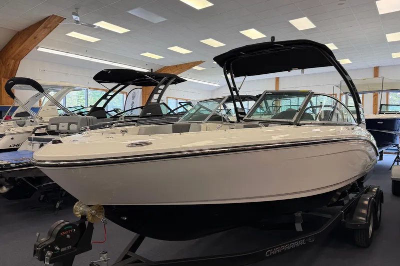 The Image of 2025 Chaparral 21 SSi OB boat displayed indoors on a trailer. - 0