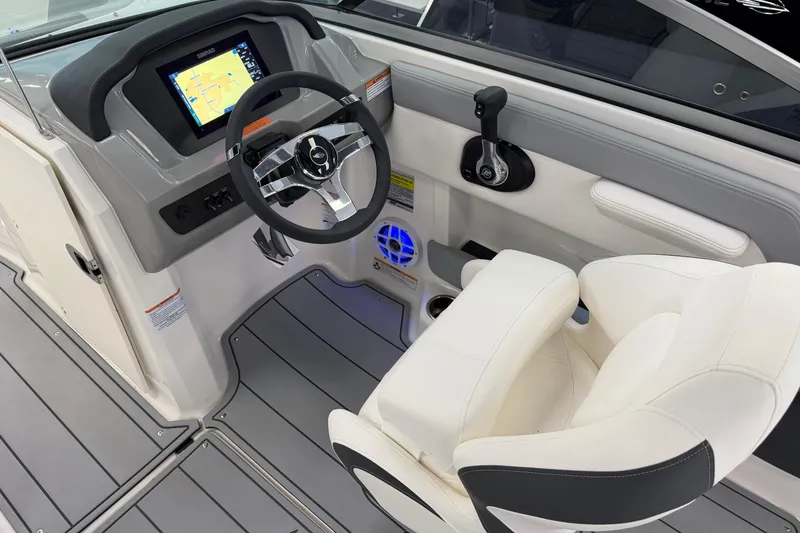 Slide: The Image of 2025 Chaparral 21 SSi OB boat cockpit with modern steering and navigation display. - 11