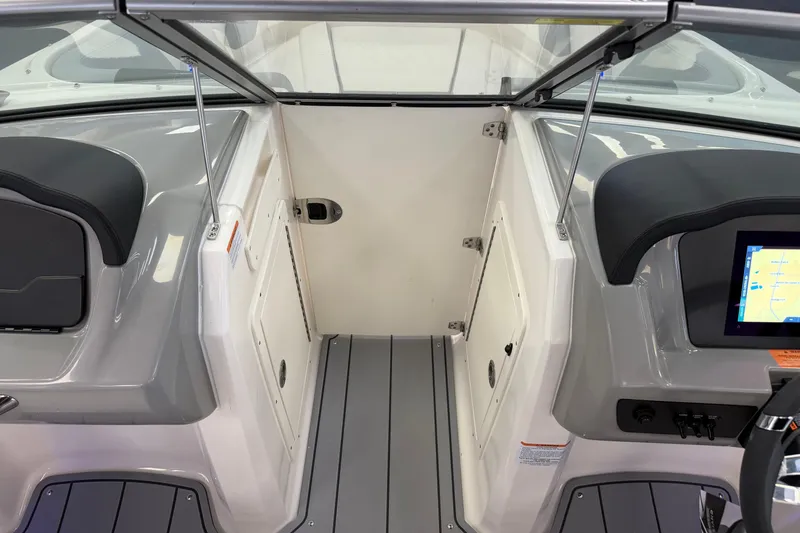 Slide: The Image of Interior view of 2025 Chaparral 21 SSi OB boat, featuring sleek dashboard and seating. - 17