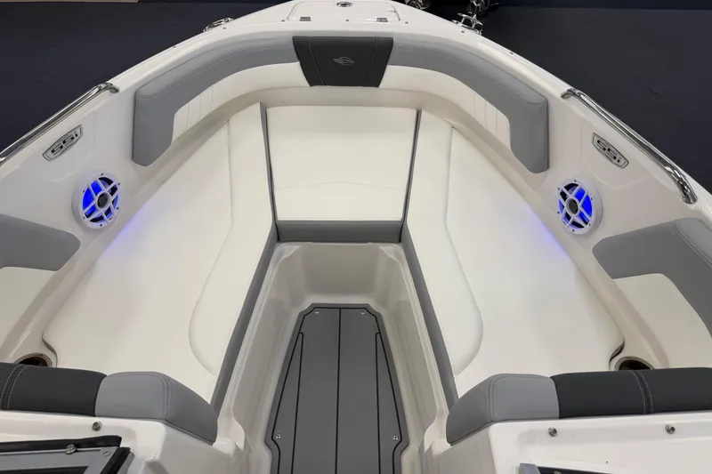Slide: The Image of 2025 Chaparral 21 SSi OB boat interior with cushioned seating and blue LED lights. - 18
