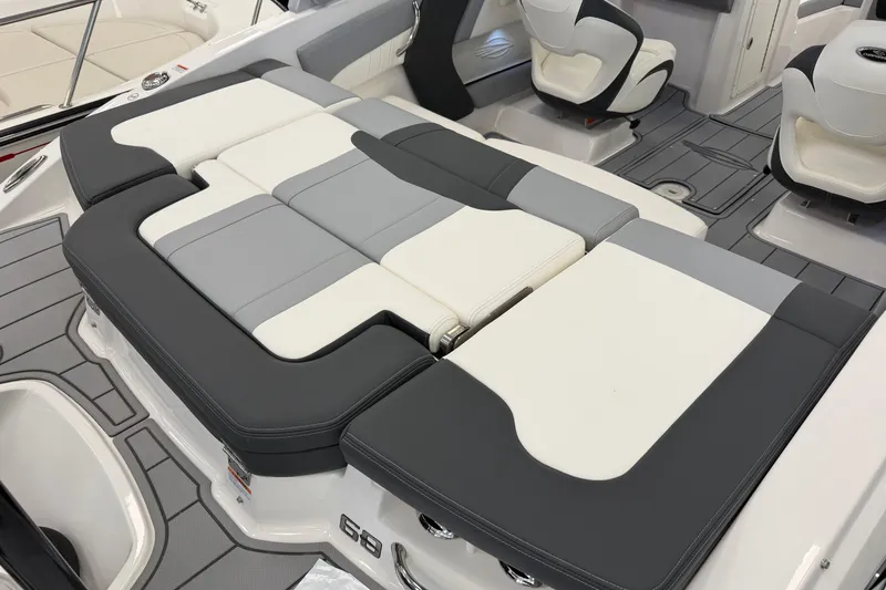 Slide: The Image of 2025 Chaparral 21 SSi OB boat interior with gray and white cushioned seating. - 5