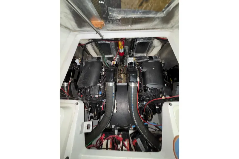 Slide: The Image of Engine compartment of a 1995 Luhrs 29 Open boat, showcasing dual engines and wiring. - 10