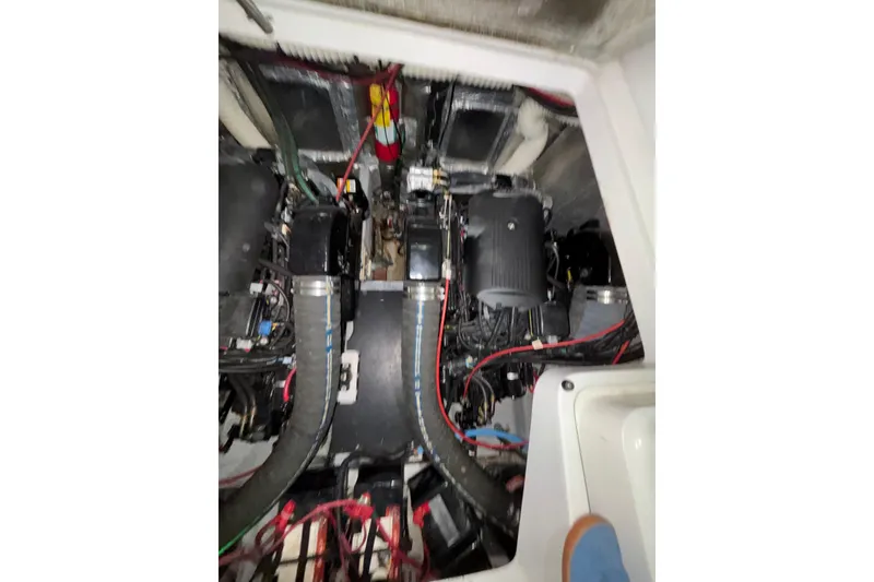 Slide: The Image of Engine compartment of a 1995 Luhrs 29 Open boat, showcasing mechanical components. - 12