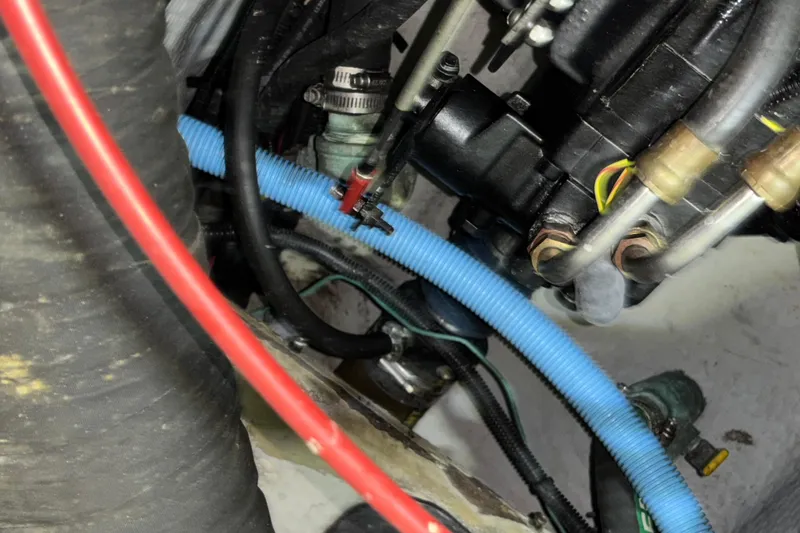 Slide: The Image of Engine compartment of a 1995 Luhrs 29 Open boat, showing hoses and wiring. - 15