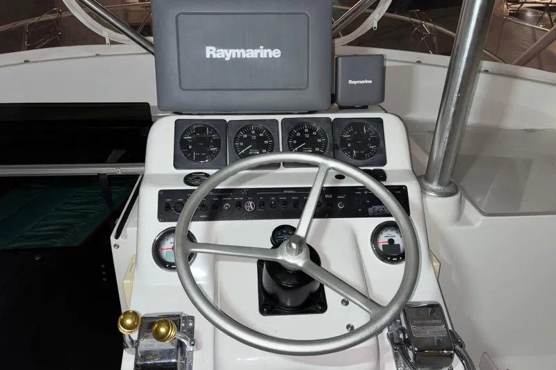 Slide: The Image of 1995 Luhrs 29 Open boat helm with Raymarine navigation system and gauges. - 16