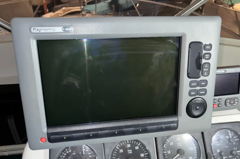 Slide: The Image of Raymarine display on 1995 Luhrs 29 Open boat dashboard with gauges. - 23