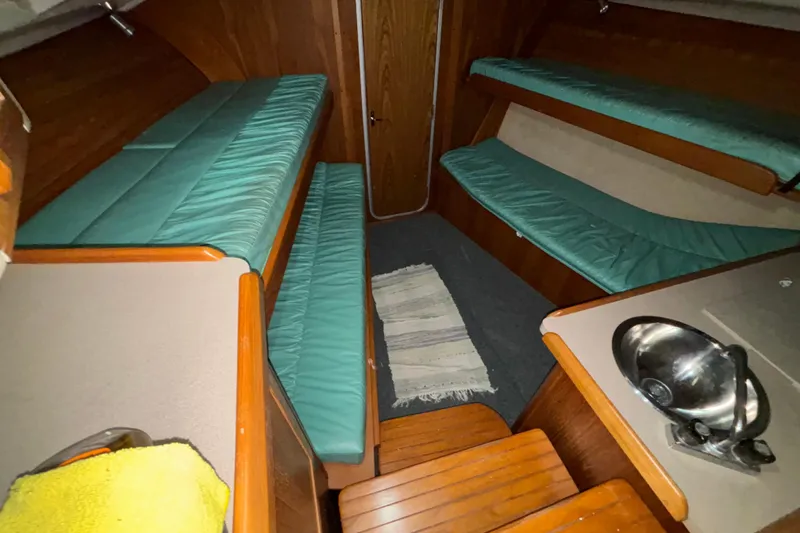 Slide: The Image of Interior of 1995 Luhrs 29 Open boat with teal cushions and compact sink. - 25