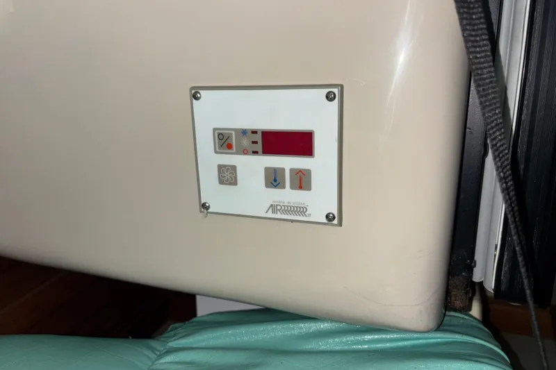 Slide: The Image of Control panel on a 1995 Luhrs 29 Open boat, featuring air conditioning settings. - 29