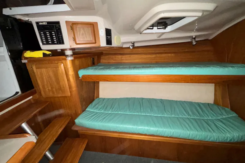 Slide: The Image of Interior of 1995 Luhrs 29 Open boat with wooden cabinetry and teal cushions. - 31