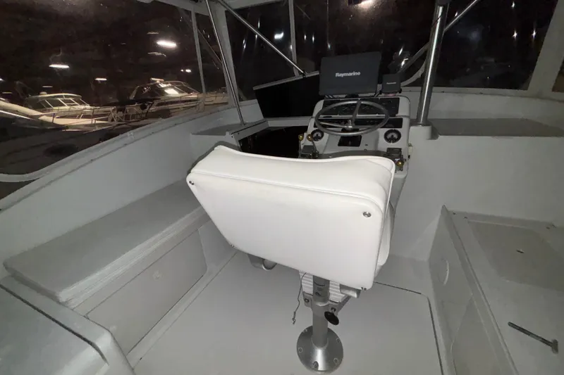Slide: The Image of 1995 Luhrs 29 Open boat cockpit with steering wheel and navigation equipment. - 34