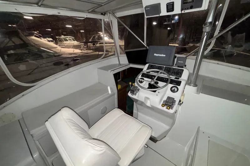 Slide: The Image of 1995 Luhrs 29 Open boat cockpit with steering wheel and navigation equipment. - 35