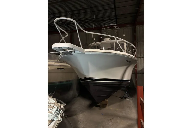 Slide: The Image of 1995 Luhrs 29 Open boat in storage, showcasing sleek design and sturdy build. - 42