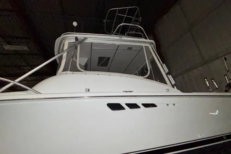 Slide: The Image of 1995 Luhrs 29 Open boat in a dimly lit indoor setting. - 5