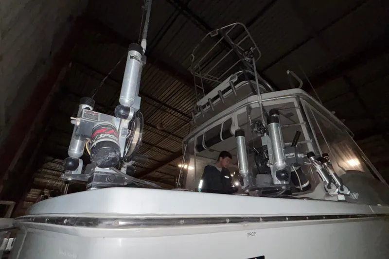 Slide: The Image of 1995 Luhrs 29 Open boat in storage, featuring fishing equipment and a person onboard. - 8