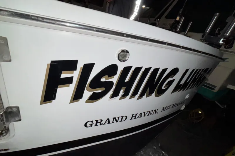 Slide: The Image of 1995 Luhrs 29 Open boat with "Fishing Liar" text, Grand Haven, Michigan. - 9