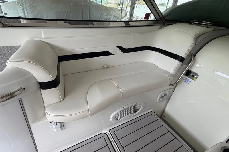 Slide: The Image of Interior seating of a 2005 Formula 330 Sun Sport boat, featuring white upholstery. - 11