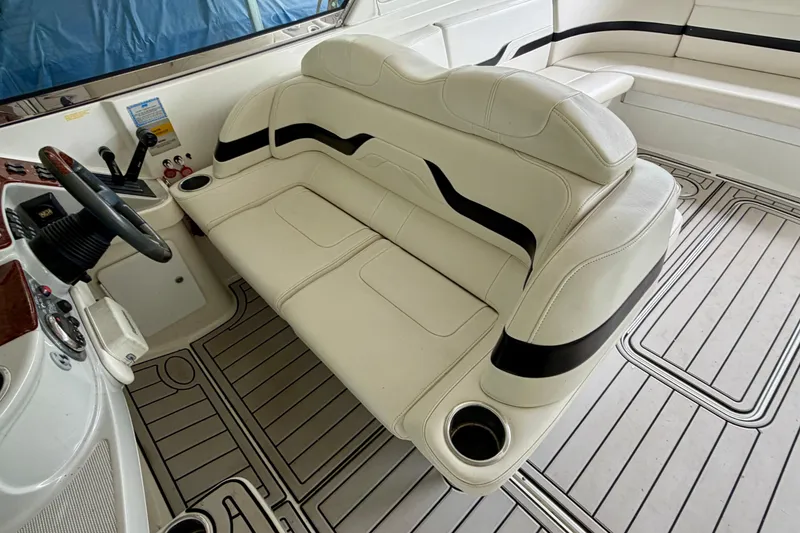 Slide: The Image of 2005 Formula 330 Sun Sport boat interior with white seating and steering console. - 13