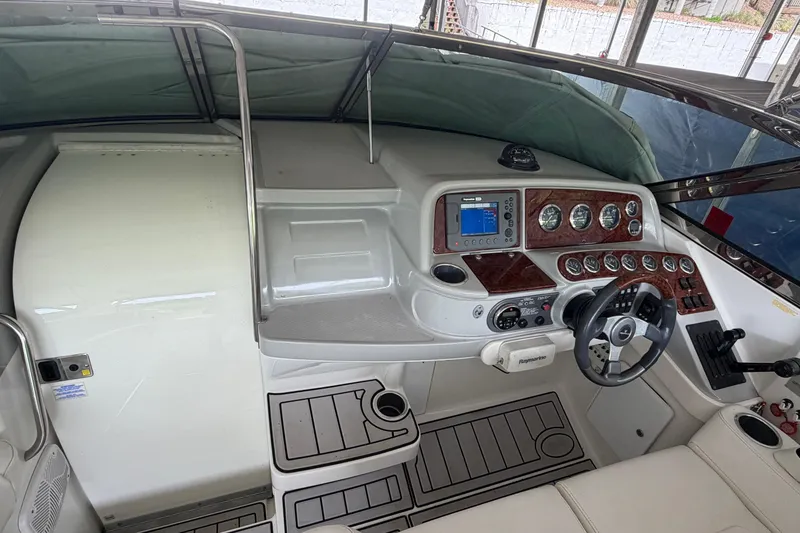 Slide: The Image of 2005 Formula 330 Sun Sport boat cockpit with steering wheel and control panel. - 14