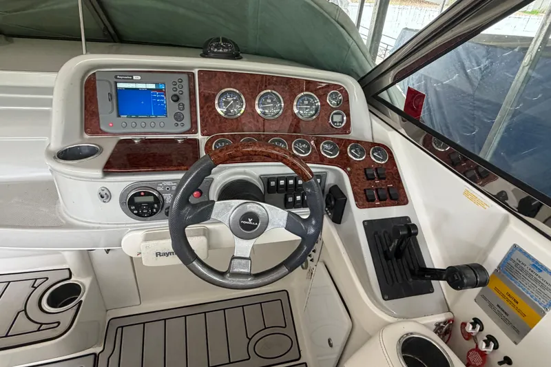 Slide: The Image of Cockpit of 2005 Formula 330 Sun Sport boat with steering wheel and navigation controls. - 15
