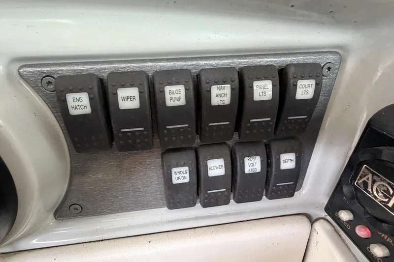Slide: The Image of Control panel of a 2005 Formula 330 Sun Sport boat with labeled switches. - 18
