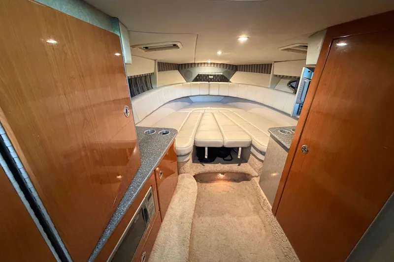 Slide: The Image of Interior of 2005 Formula 330 Sun Sport boat with plush seating and wood cabinetry. - 22