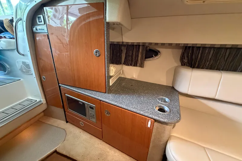 Slide: The Image of Interior of 2005 Formula 330 Sun Sport boat with kitchenette and seating area. - 24
