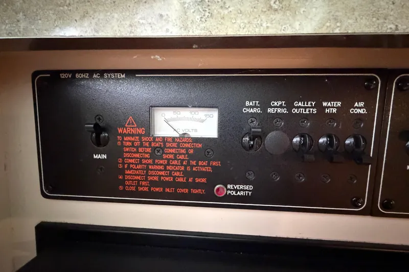 Slide: The Image of Control panel of a 2005 Formula 330 Sun Sport boat, showing 120V AC system settings. - 27