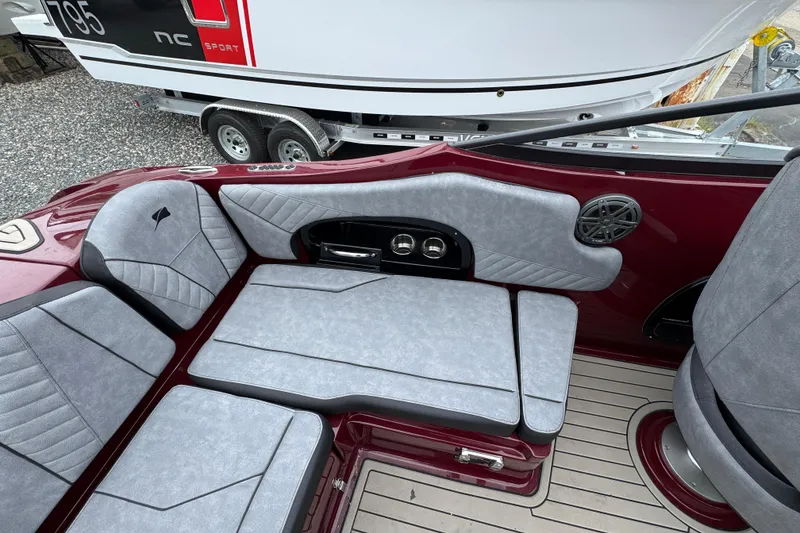 Slide: The Image of 2026 Stingray 23 OCX boat interior with gray seating and maroon accents. - 10
