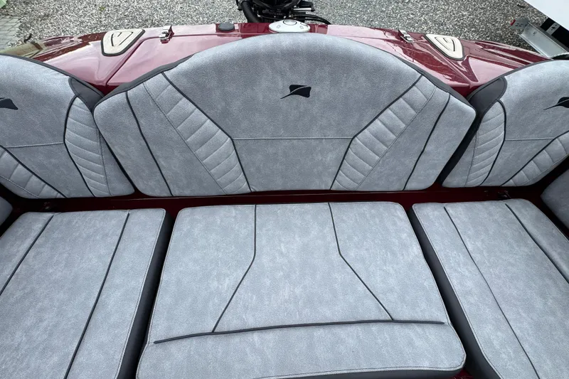 Slide: The Image of 2026 Stingray 23 OCX boat interior with gray cushioned seating and sleek design. - 11