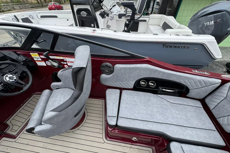 Slide: The Image of Interior of 2026 Stingray 23 OCX boat with modern seating and steering wheel. - 14