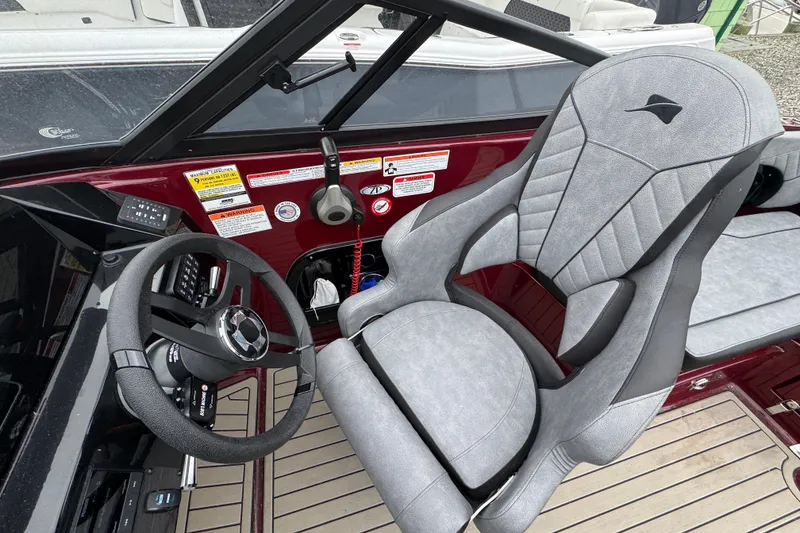 Slide: The Image of 2026 Stingray 23 OCX boat interior with sleek steering wheel and modern captain's chair. - 15