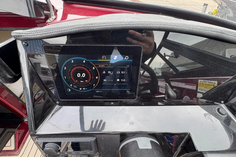 Slide: The Image of Dashboard of a 2026 Stingray 23 OCX boat with digital display and controls. - 17