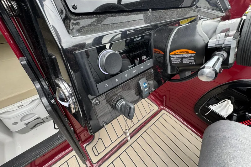 Slide: The Image of Dashboard of a 2026 Stingray 23 OCX boat with control panel and steering. - 18