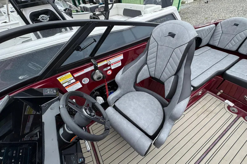 Slide: The Image of 2026 Stingray 23 OCX boat interior with sleek steering wheel and modern seating. - 30